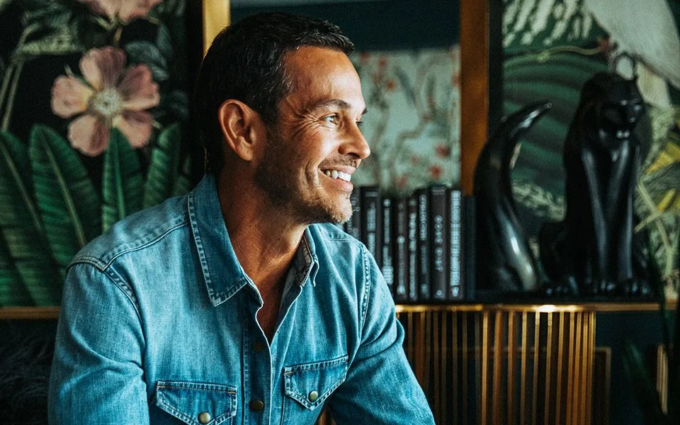 John Burgos smiling, looking toward the light